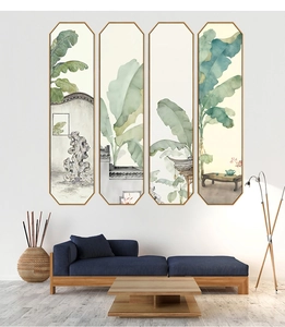 Detail of four-piece ink banana leaf wall art panels above a blue fabric sofa