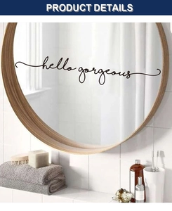 Detail showing 'hello gorgeous' cursive wall decal applied to a round bathroom mirror