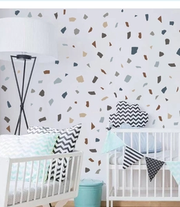 Detail of gray marble terrazzo wall stickers on a nursery wall with modern furniture