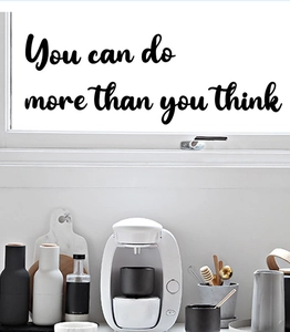 Detail of You Can Do More Than You Think black vinyl wall sticker on a bright glass window