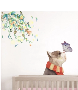 Detail of creative hand-painted wall sticker featuring a cat and green leaf vine decoration
