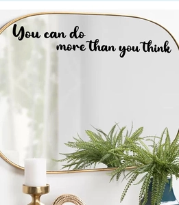 Detail of inspirational 'You can do more than you think' quote sticker on a mirror