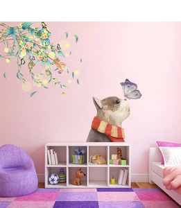 Detail of cute cat and butterfly wall sticker in a cozy nursery room setting