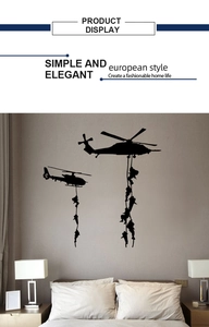 Detail view of military helicopter and soldier silhouette wall decals on a bedroom wall