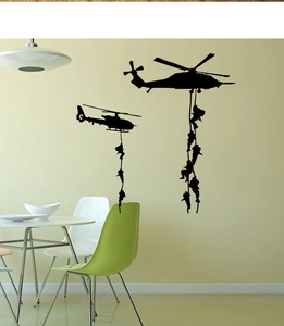 Detail of black military helicopter silhouettes and soldiers rappelling on wall