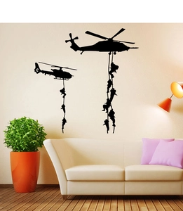 Detail view of helicopter and soldier silhouette wall decals on a living room wall