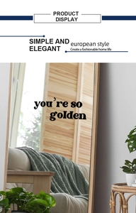 Detail showing 'you're so golden' black art lettering on a wood framed mirror
