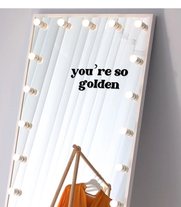 Detail of you are so golden wall decal on a Hollywood style LED lighted vanity mirror