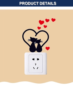 Detail showing cartoon couple cats and red heart wall sticker on a white light switch