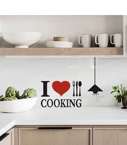 Close-up of DIY kitchen wall sticker with black letters and red heart on white tiles