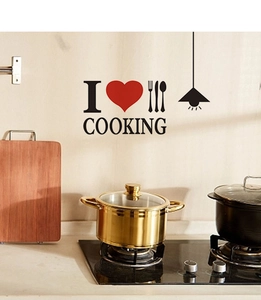 Macro detail of DIY kitchen wall decal featuring black letters and a red heart icon