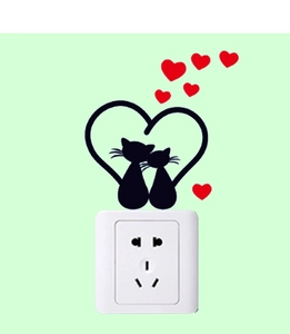Detail of cartoon cat wall sticker silhouettes with red hearts above a white light switch