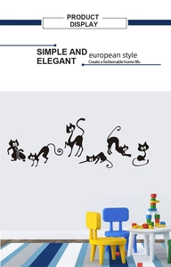 Detail showing five different black cat silhouette wall stickers on a clean white wall