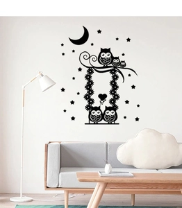 Detail of cartoon owl swing wall decal stickers in a modern minimalist living room setting
