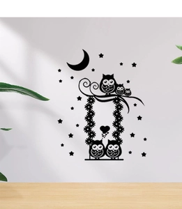 Detail of cartoon owl silhouette wall sticker with crescent moon and swing on white wall