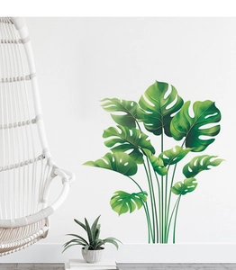 Close-up of tropical monstera leaf wall decals in a modern Nordic minimalist living room