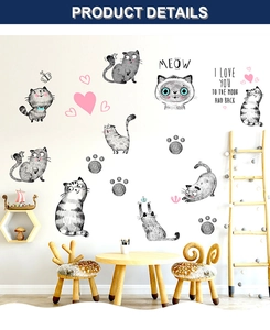 Detail view of cute cartoon cat wall stickers with hand-drawn designs on nursery room wall