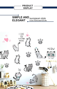 Detailed view of cute hand-drawn cat wall stickers applied to a cozy nursery wall