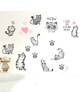 Detail of cartoon cat wall stickers with heart patterns and Meow text on a white wall