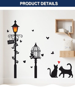 Detail of black cat and street lamp wall sticker with LOVE sign on white wall