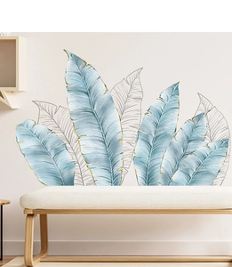 Detail view of tropical banana leaf wall stickers with gold edges in a modern bedroom decor