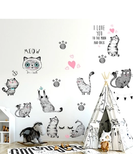 Detail of cartoon cat wall stickers and Meow text in a cozy nursery room setting