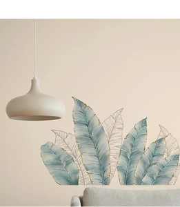 Detail of tropical banana leaf wall sticker with gold lines in a modern Nordic living room