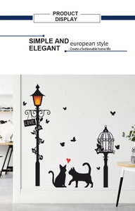 Detail showing black silhouette wall stickers with cat, street lamp and LOVE sign on wall