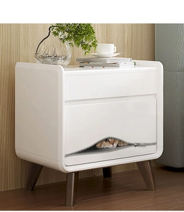 Close-up of modern white bedside table featuring a unique cat pattern and wood legs