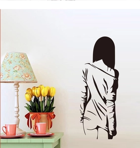 Modern black wall decal showing an elegant female silhouette in a cozy living room decor