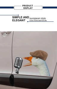 Detail showing a funny goose with hat and vintage microphone sticker on a car door