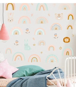 Detail of rainbow and animal wall decals in a cozy children room with soft macaron colors
