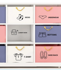 Close-up of minimalist black wardrobe organizer labels on pastel storage bins