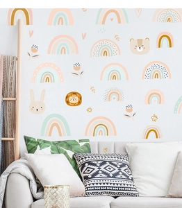Detail of cartoon rainbow and animal wall stickers in a cozy nursery room setting