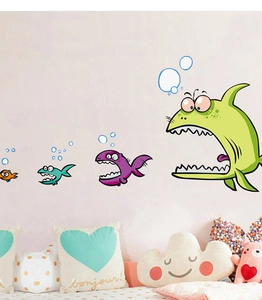 Detailed view of colorful cartoon fish wall stickers in a cozy nursery room setting