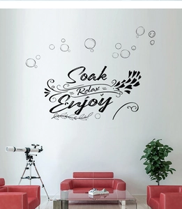 Modern living room wall decor showing Soak Relax Enjoy bubble stickers above a red sofa