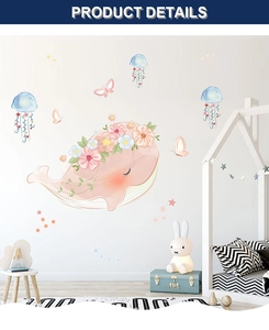 Detail view of pink whale wall decals with watercolor jellyfish in a cozy child's bedroom