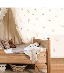 Detail of warm brown dandelion seed wall decals in a cozy bohemian nursery setting