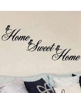 Detail view of Home Sweet Home wall decal with butterfly accents in a cozy living room decor