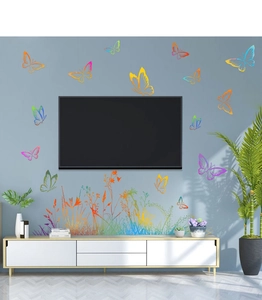 Colorful butterfly and green plant wall stickers surrounding a TV in a modern living room