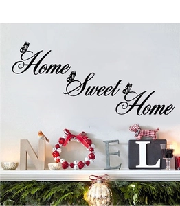 Detail view of Home Sweet Home wall decal with black butterfly accents on a white wall