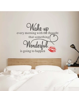 Detail of Wake Up Wonderful inspirational wall decal with red lips and heart over a bed
