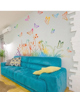 Colorful butterfly and rainbow plant wall stickers decorating a modern living room wall