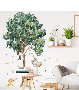 Close-up of cute cartoon cats and a lush green tree wall decal in a cozy room setting