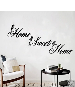 Detail of Home Sweet Home wall decal with black butterfly accents in a modern living room