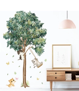 Detail showing a cute cat and tree wall sticker set in a cozy living room scene