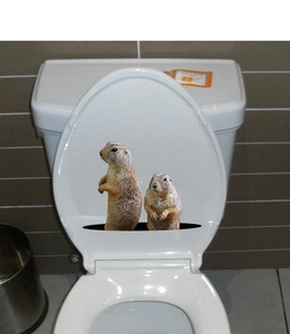 Detailed view of 3D groundhog wall stickers applied to a white bathroom toilet lid