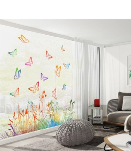Detail of colorful butterfly and plant wall stickers on a glass window in a bright living room