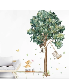 Detail of cute cartoon cats playing on a green tree wall decal for nursery rooms