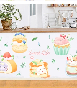 Detail of cute animal cupcakes and sweet dessert wall stickers on a kitchen cabinet